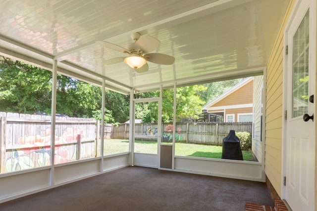 unfurnished sunroom with a ceiling fan