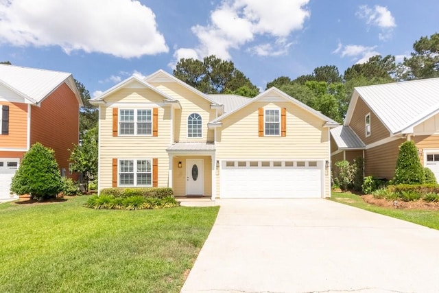 traditional home with an attached garage, driveway, and a front yard