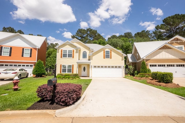 traditional-style home with a garage, a front lawn, and concrete driveway