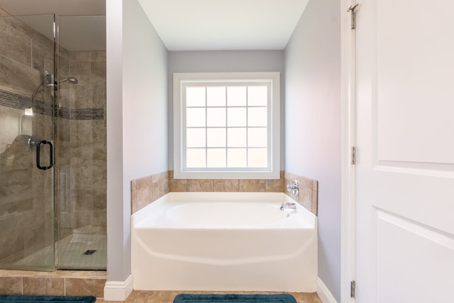 full bath featuring a stall shower and a garden tub