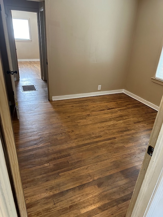 unfurnished room featuring dark hardwood / wood-style flooring