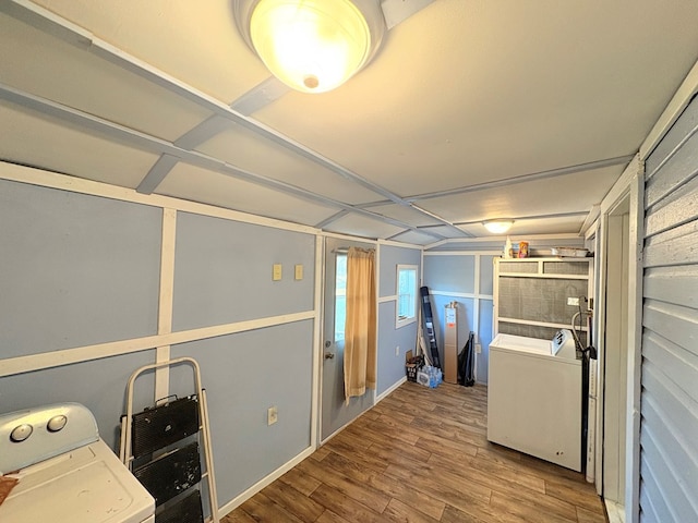 clothes washing area featuring laundry area, wood finished floors, and washer and dryer