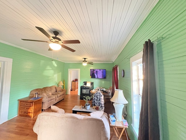 living area with ornamental molding, wood ceiling, and wood finished floors