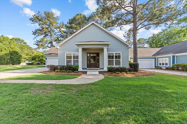 view of front of home with a garage, driveway, and a front lawn