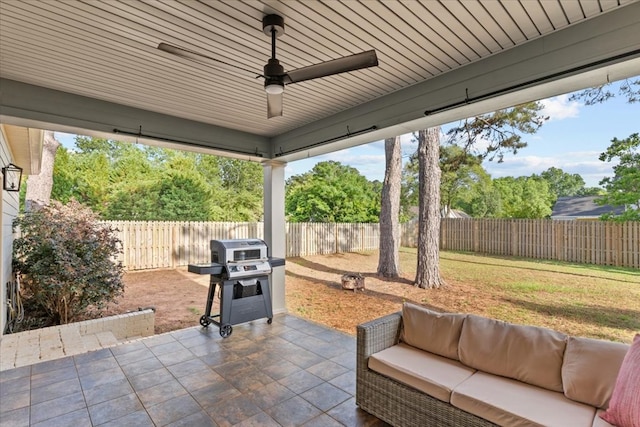 view of patio / terrace featuring grilling area, an outdoor living space, a ceiling fan, and a fenced backyard