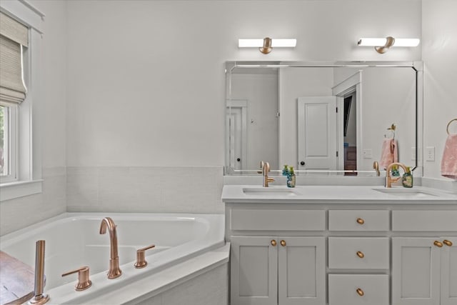 full bathroom featuring vanity and a bath