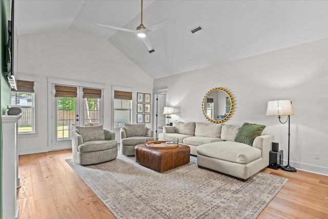 living area featuring visible vents, high vaulted ceiling, french doors, a ceiling fan, and light wood finished floors