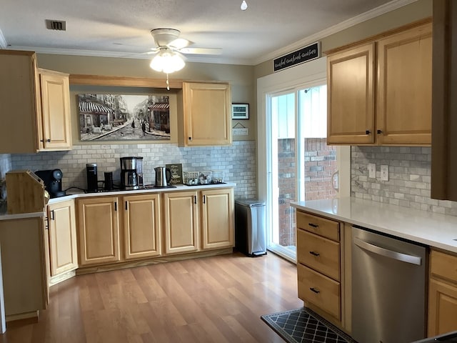 210 E Hickory Bend Rd, Enterprise, AL 36330 - kitchen with stainless steel dishwasher, light brown cabinets, light countertops, decorative backsplash, and light wood finished floors