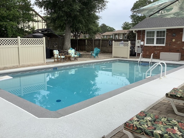 210 E Hickory Bend Rd, Enterprise, AL 36330 - view of swimming pool featuring a fenced backyard and a fire pit