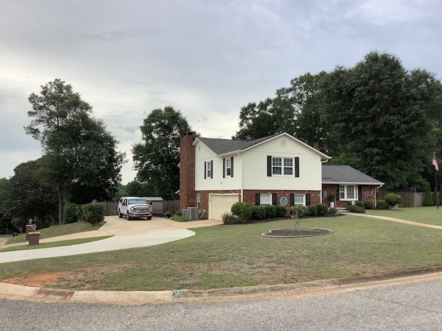 210 E Hickory Bend Rd, Enterprise, AL 36330 - split level home with concrete driveway, an attached garage, a chimney, central air condition unit, and brick siding