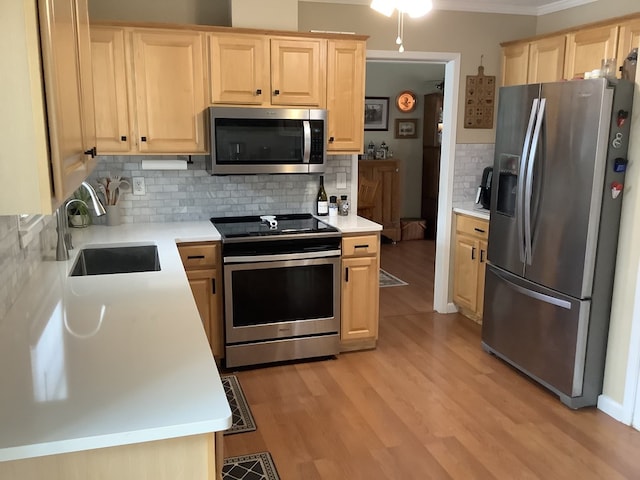 210 E Hickory Bend Rd, Enterprise, AL 36330 - kitchen featuring stainless steel appliances, light brown cabinetry, a sink, tasteful backsplash, and crown molding