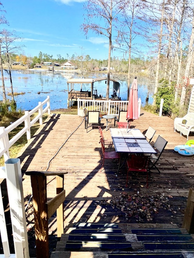 dock area featuring a deck with water view