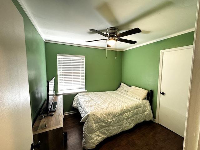 bedroom with ceiling fan, dark hardwood / wood-style flooring, and ornamental molding