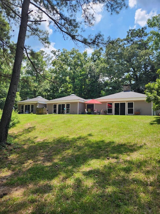 1442 Jernigan Rd, Ozark, AL 36360 - rear view of property with a yard and a chimney
