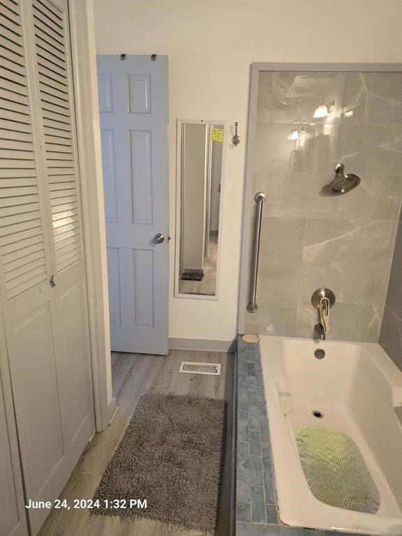 1442 Jernigan Rd, Ozark, AL 36360 - bathroom featuring a closet, wood finished floors, and bathtub / shower combination
