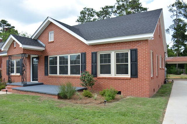 203 E Mckinnon St, New Brockton, AL 36351 - view of front facade with roof with shingles, brick siding, and a front yard