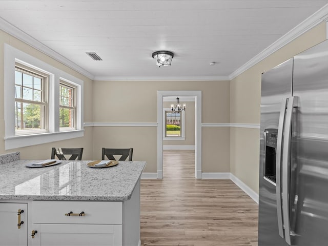 203 E Mckinnon St, New Brockton, AL 36351 - kitchen featuring stainless steel fridge with ice dispenser, light wood-type flooring, a chandelier, ornamental molding, and white cabinets