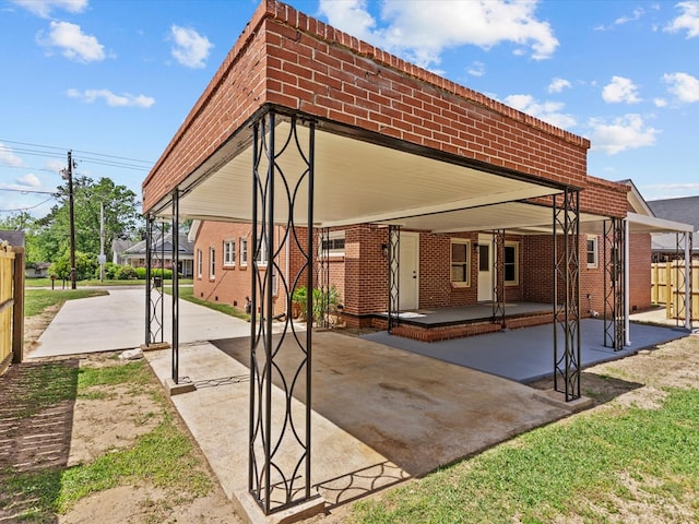 203 E Mckinnon St, New Brockton, AL 36351 - rear view of property with brick siding and a patio