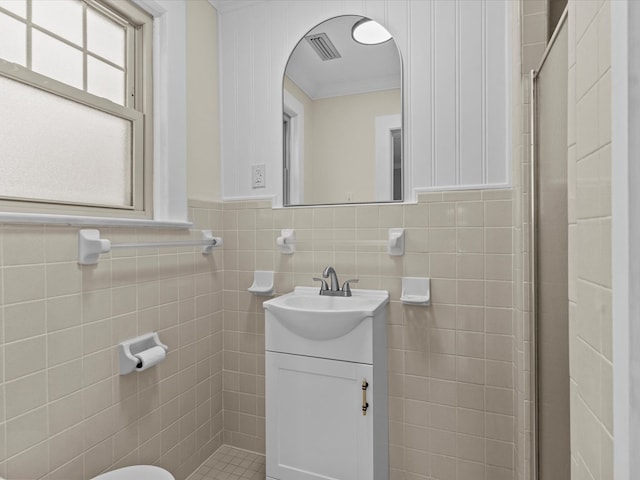 203 E Mckinnon St, New Brockton, AL 36351 - full bathroom featuring ornamental molding, vanity, a stall shower, and tile walls