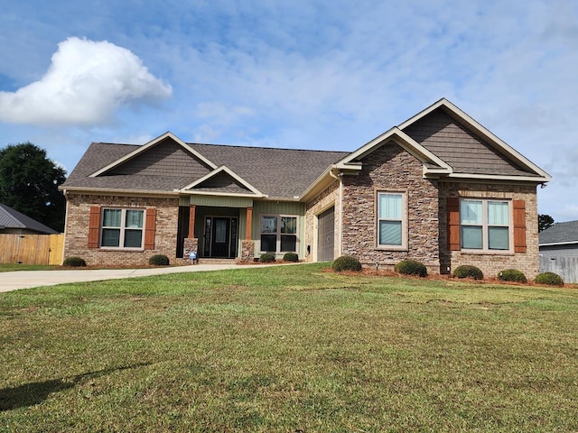 craftsman house featuring a garage and a front lawn