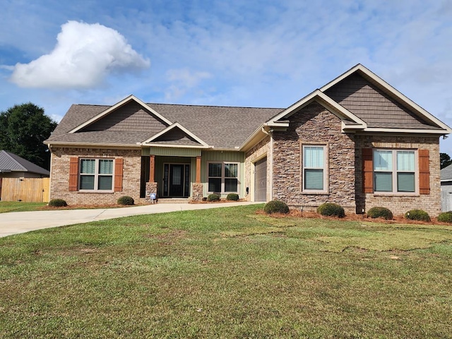 craftsman-style house featuring a garage and a front yard