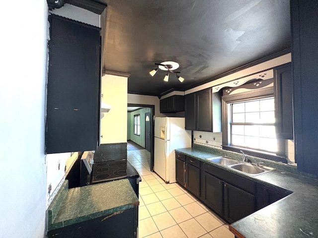 176 Camilla Ave, Ozark, AL 36345 - kitchen featuring a sink, dark countertops, light tile patterned floors, freestanding refrigerator, and electric stove