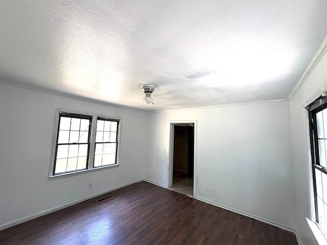 176 Camilla Ave, Ozark, AL 36345 - empty room featuring dark wood finished floors, crown molding, baseboards, ceiling fan, and a textured ceiling