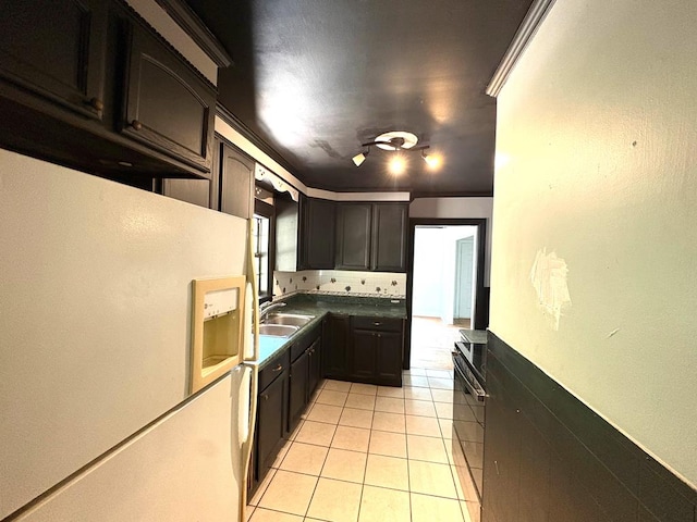 176 Camilla Ave, Ozark, AL 36345 - kitchen with freestanding refrigerator, light tile patterned floors, a sink, tasteful backsplash, and black electric range oven