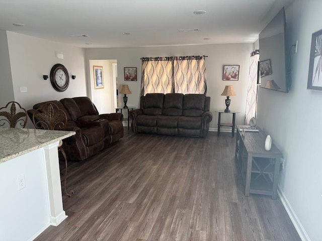 living room featuring dark wood-type flooring