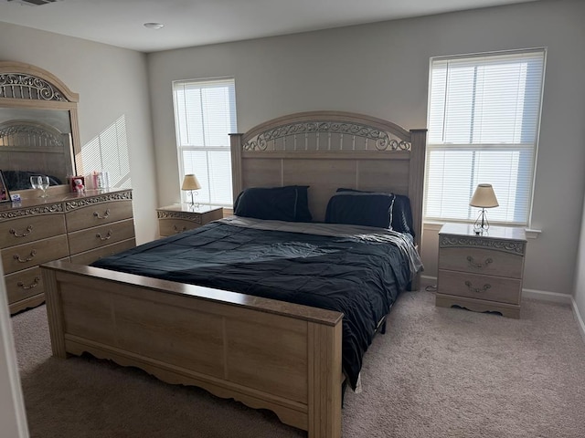 bedroom featuring light colored carpet