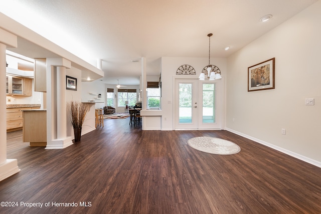 foyer with french doors, dark hardwood / wood-style flooring, and a chandelier