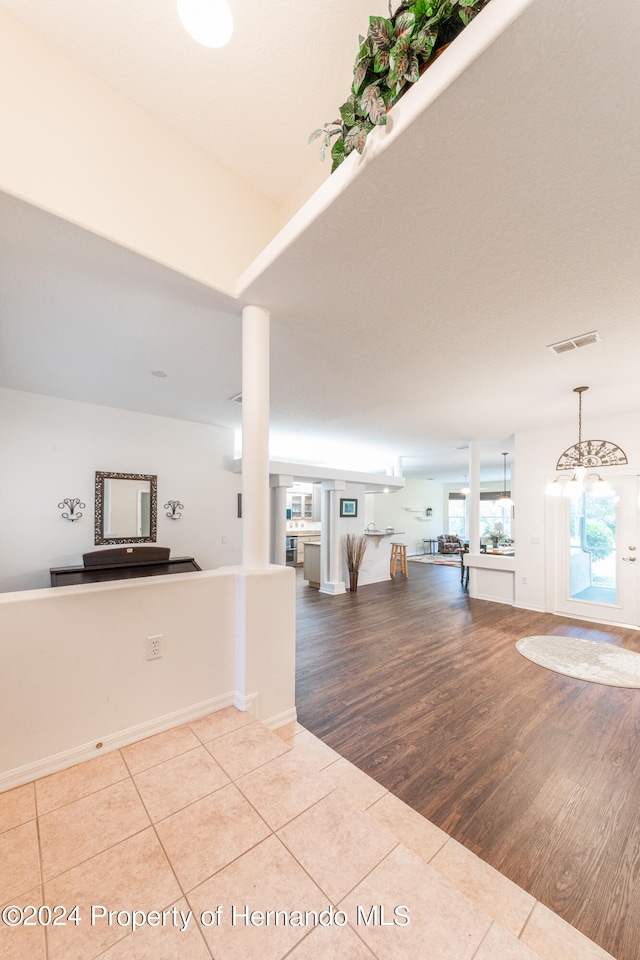 entryway featuring an inviting chandelier and light hardwood / wood-style flooring