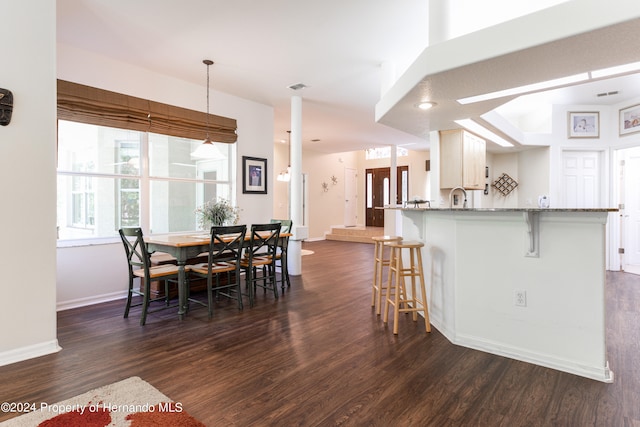 dining space featuring dark hardwood / wood-style flooring and sink