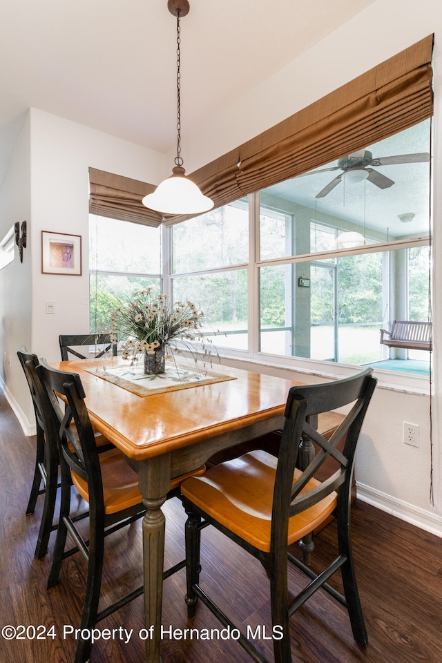 dining room with ceiling fan, a healthy amount of sunlight, and dark hardwood / wood-style flooring