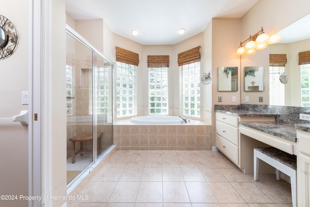 bathroom with vanity, tile patterned flooring, a healthy amount of sunlight, and separate shower and tub