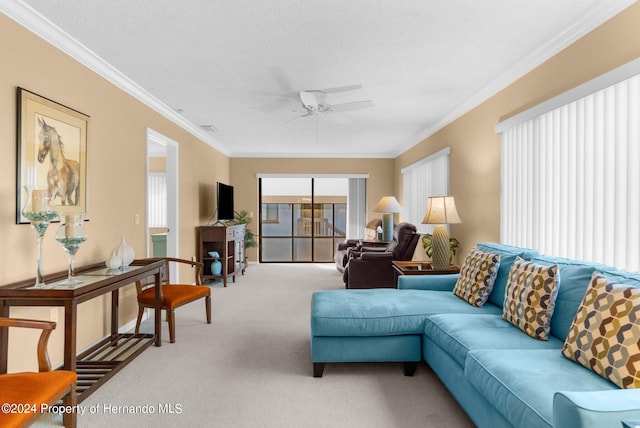 living room with ornamental molding, carpet, a textured ceiling, and ceiling fan