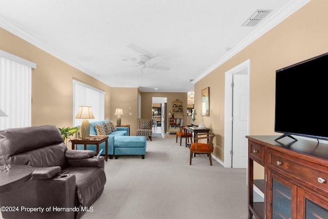 carpeted living room with ceiling fan and ornamental molding