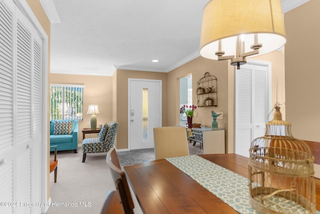 carpeted dining room featuring crown molding