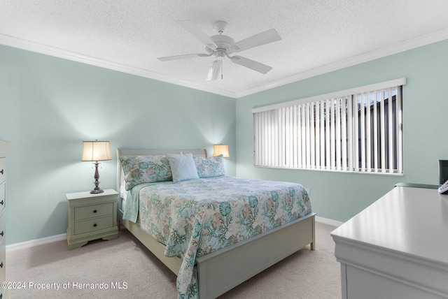 carpeted bedroom featuring ornamental molding, a textured ceiling, and ceiling fan