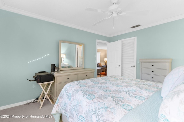 bedroom featuring ceiling fan, light carpet, a closet, and crown molding