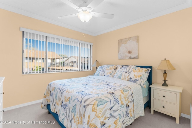 bedroom featuring ceiling fan, ornamental molding, and light colored carpet