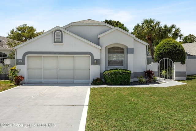 single story home featuring a garage and a front yard