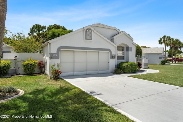 ranch-style home featuring a garage and a front yard