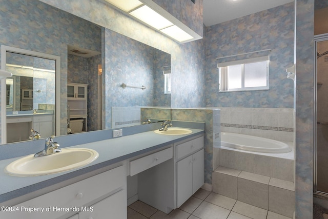 bathroom featuring vanity, tiled bath, and tile patterned floors