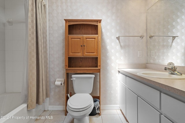 full bathroom with toilet, vanity, shower / bath combo with shower curtain, and tile patterned floors