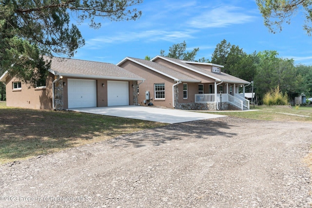 single story home with a garage and covered porch