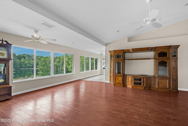 unfurnished living room with dark wood-type flooring, ceiling fan, and a textured ceiling