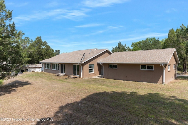 rear view of house with a lawn