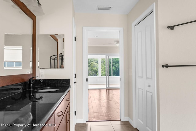 bathroom with ceiling fan, wood-type flooring, and vanity