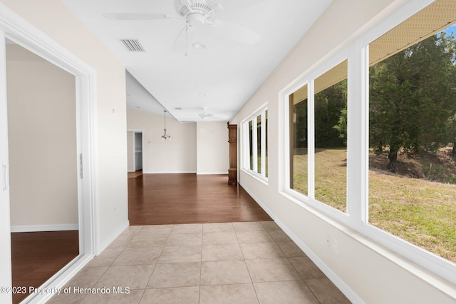 hall featuring light wood-type flooring and lofted ceiling